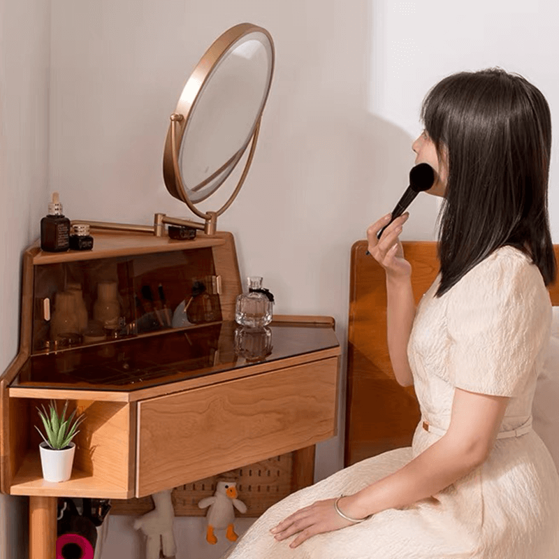 Close-up of the lighted mirror and drawer of the corner vanity, perfect for daily beauty routines.