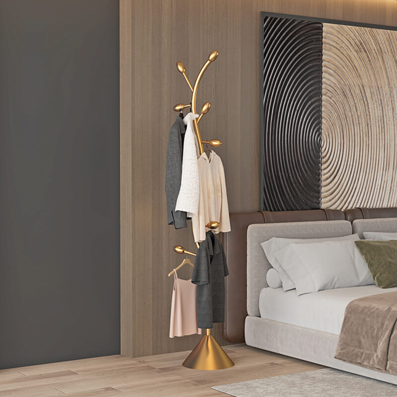 The Gold Spiral Abstract Coat Rack placed in a modern living room, demonstrating its aesthetic appeal.