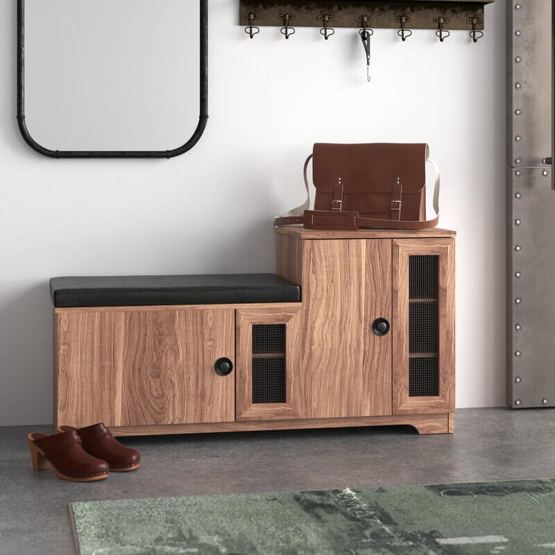 Shoe bench in entryway setting holding boots, bags, and decorative items