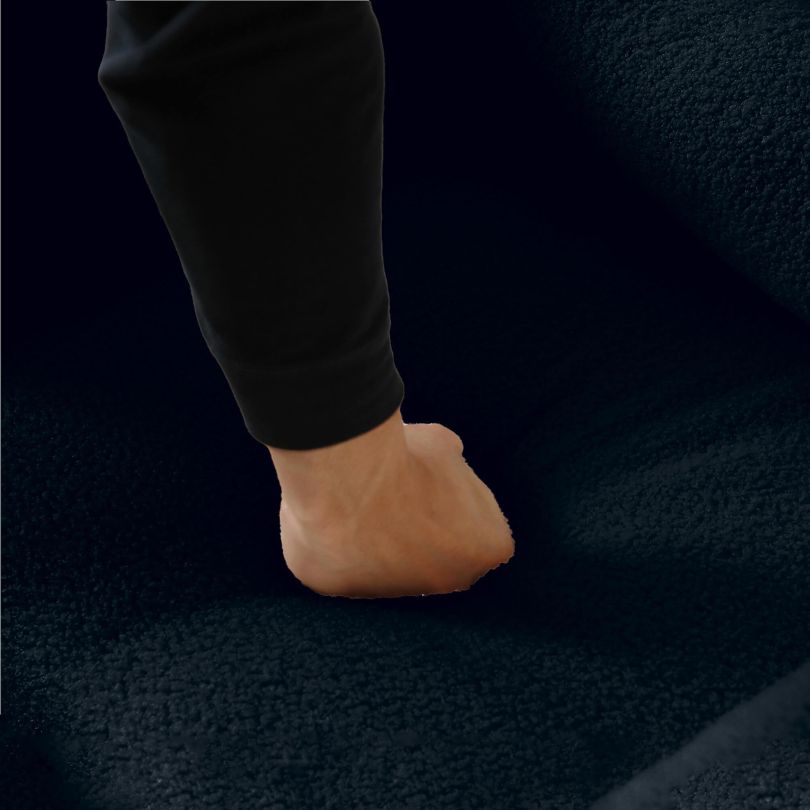 Close-up view of the plush teddy fabric on the dark blue accent chair, highlighting its comfort.
