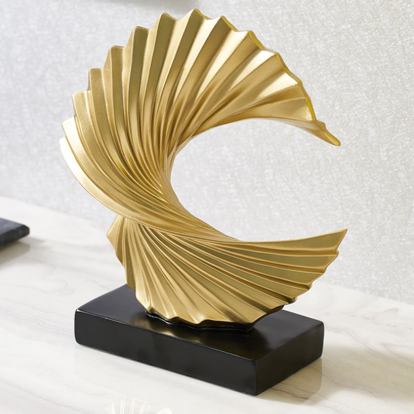 Elegant display of the golden abstract statue on a contemporary tabletop.