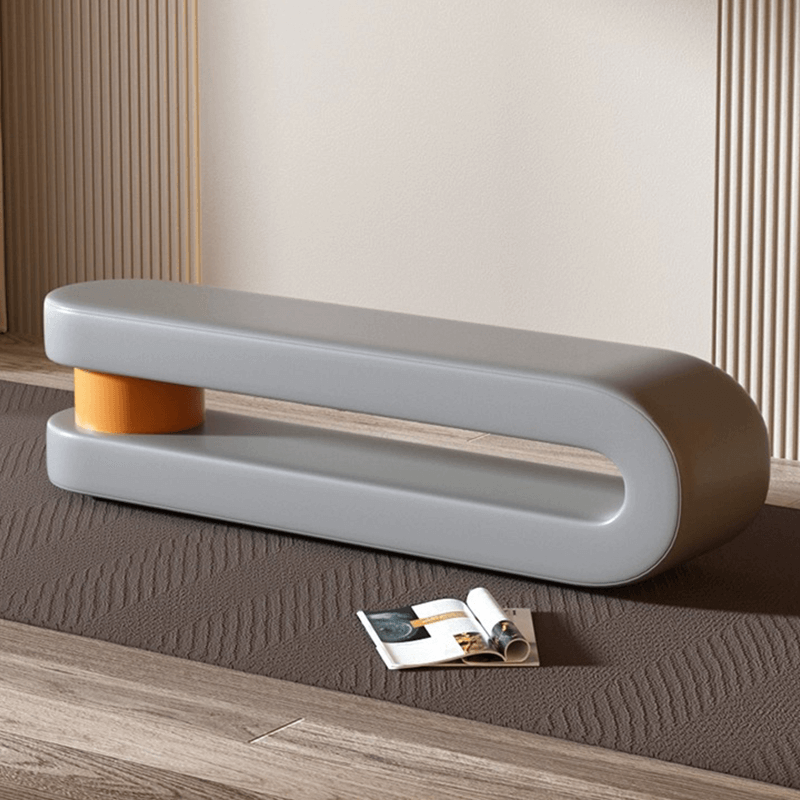 Futuristic upholstered leather loop bench in a stylish living room setting.