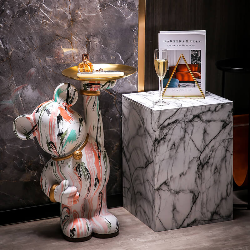 Graffiti bear sculpture placed in a stylish living room setting.