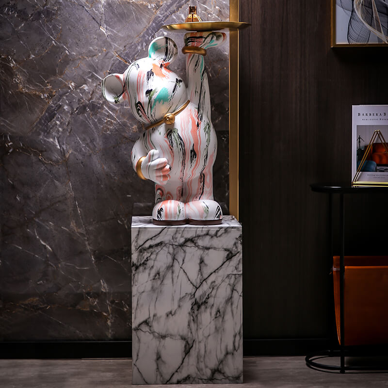 Angled view of vibrant graffiti bear sculpture showcasing colorful design.