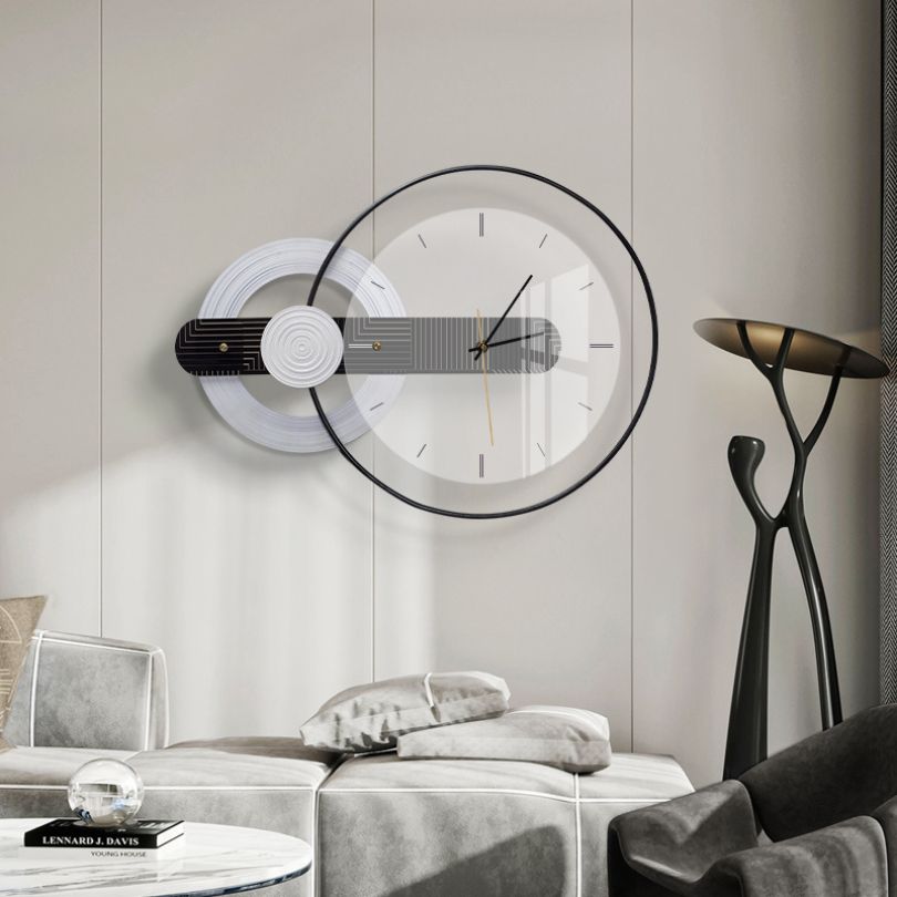 Elegant round glass wall clock displayed in a modern living room.