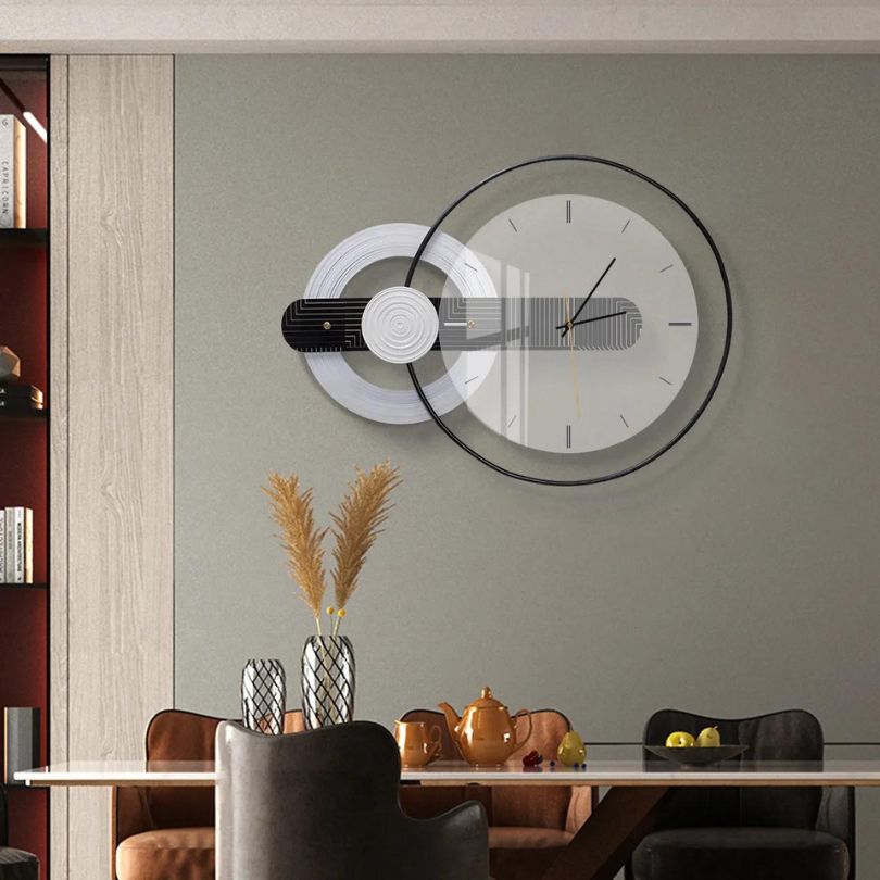 Elegant round glass wall clock displayed in a modern living room.