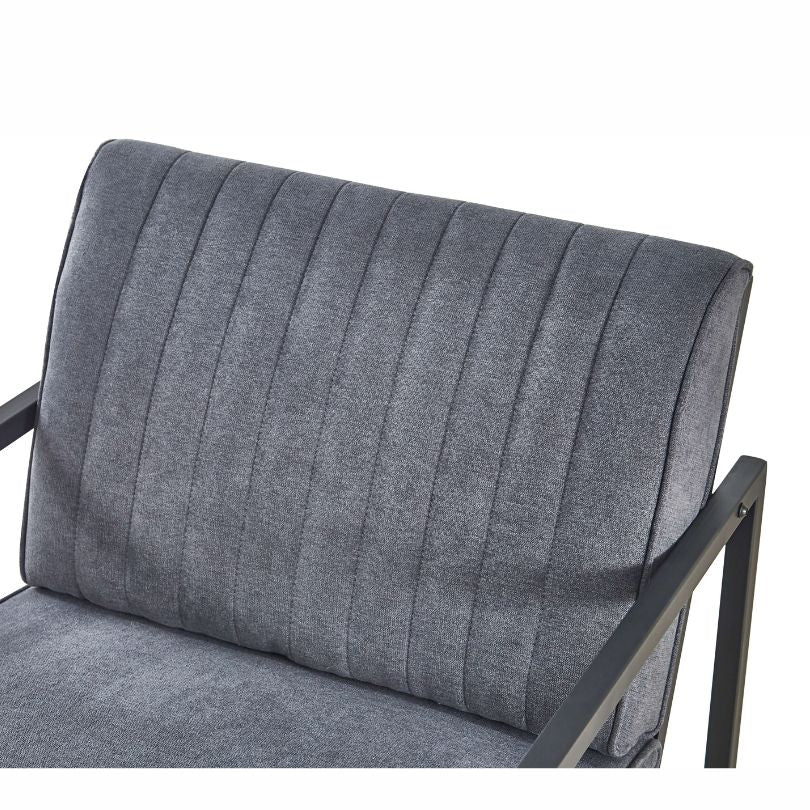 Angled view of modern armchair highlighting velvet cushion and steel legs