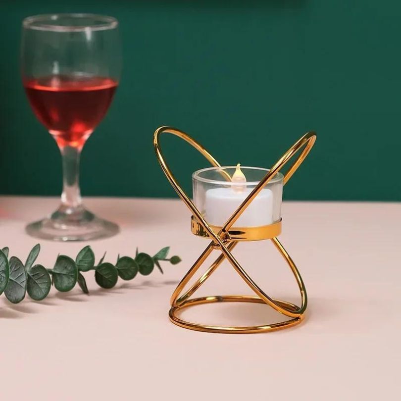 Versatile gold candle holder displayed on a beautifully set dining table, perfect for gatherings.
