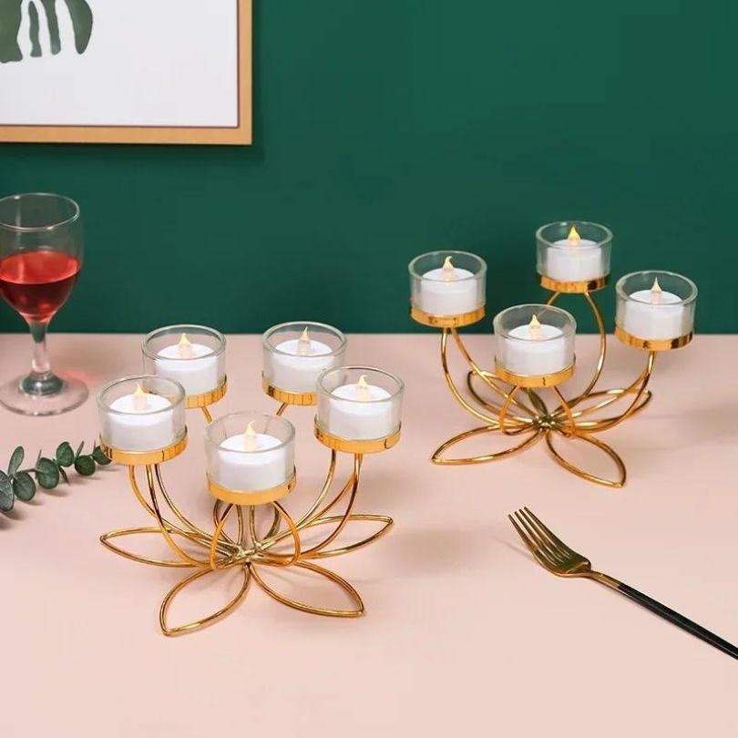 Elegant gold candle holder showcasing the warm glow of a stick candle on a dining table.