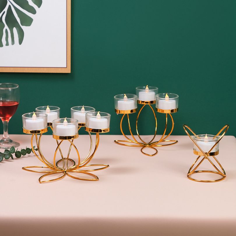 Close-up of the modern gold candlestick holder, highlighting its intricate design and finish.