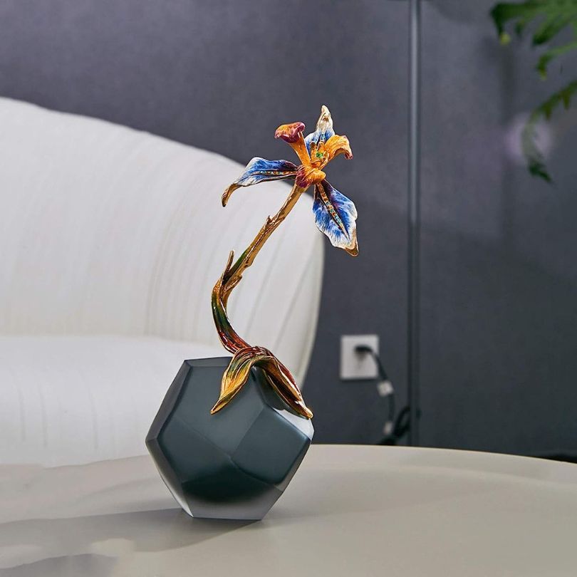 Stylish enamel glass vase as a centerpiece in a cozy dining room setting.