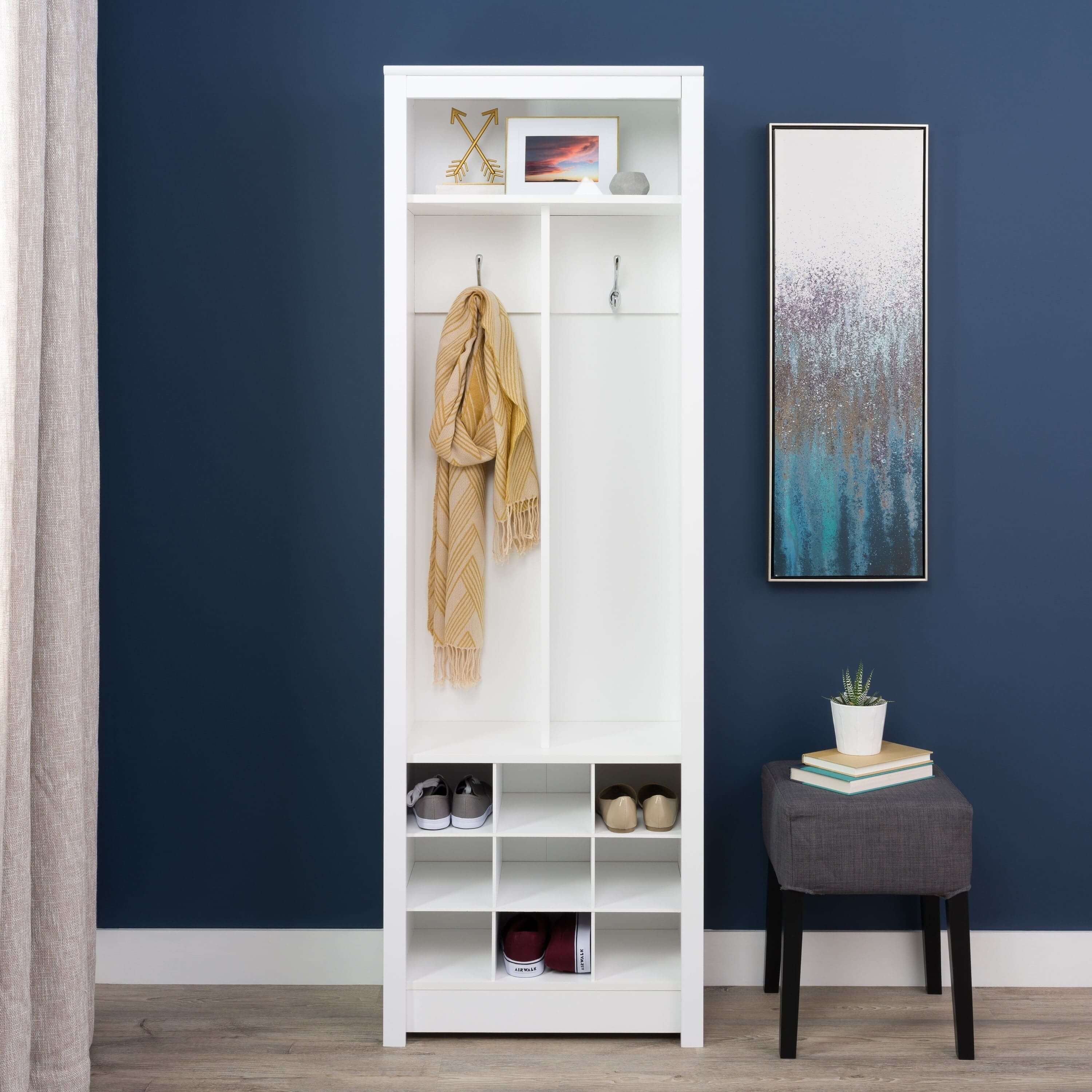 Sleek entryway organizer showcasing coat hooks and shoe cubbies from a side angle.