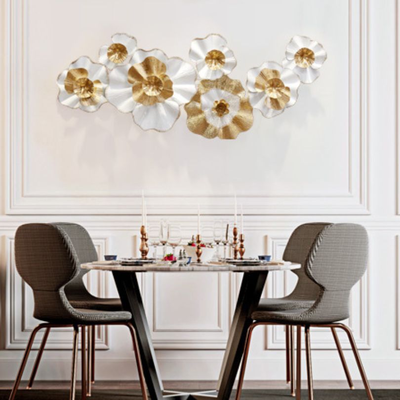 Stunning modern metal flower wall art displayed in a living room setting.