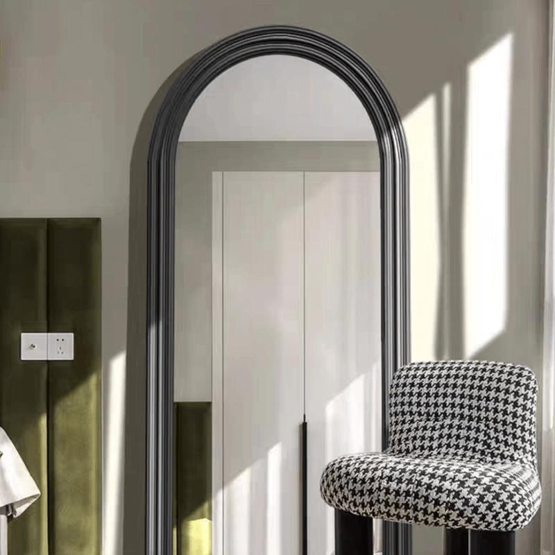 Elegant black arched frame full length wall mirror showcasing its sleek design.