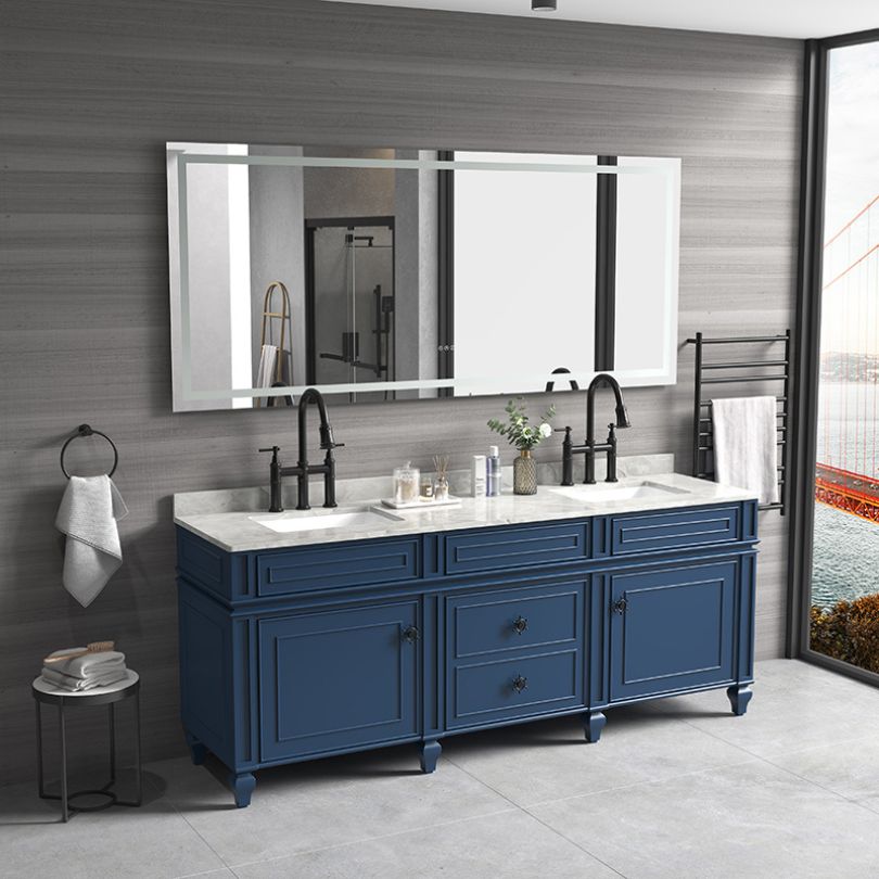 Frameless bathroom mirror with adjustable LED lights, shown in a stylish bathroom setting.