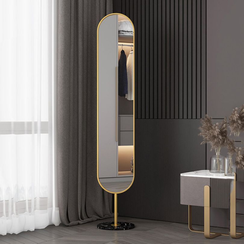 Sleek full-length freestanding mirror in a black frame placed next to a modern vanity.