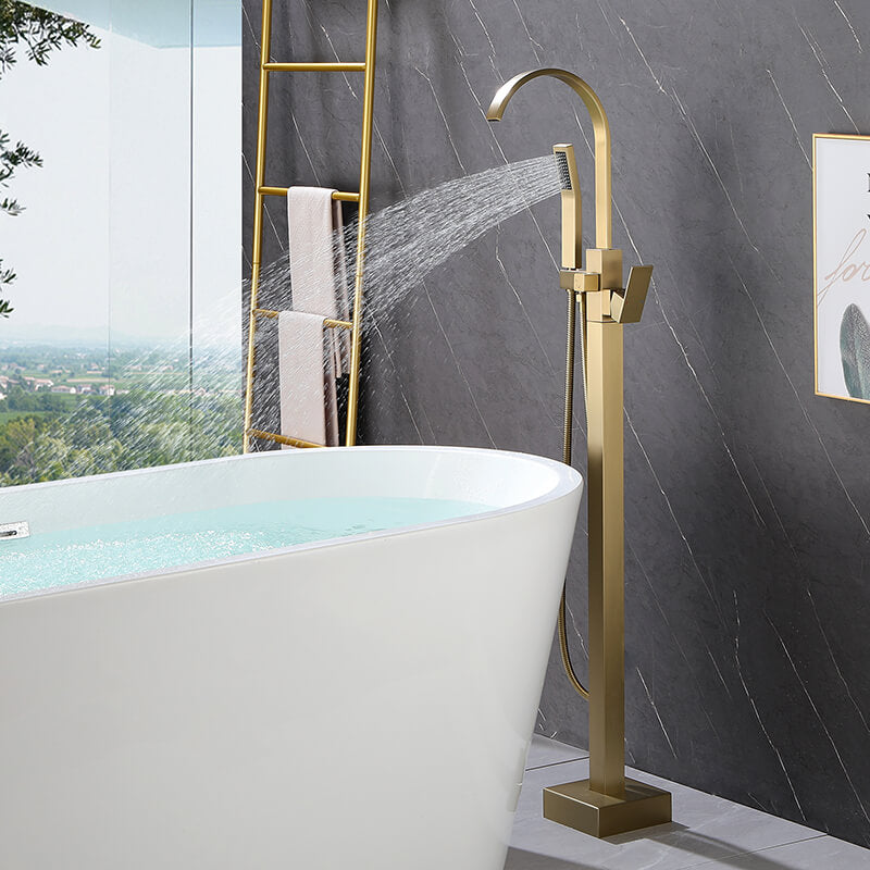 Close-up of the elegant gold floor-mounted clawfoot tub faucet showcasing its luxurious design.