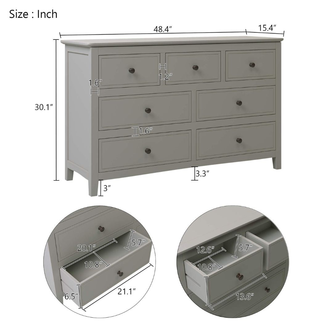 Angled view of the stylish gray dresser in a cozy bedroom setting.