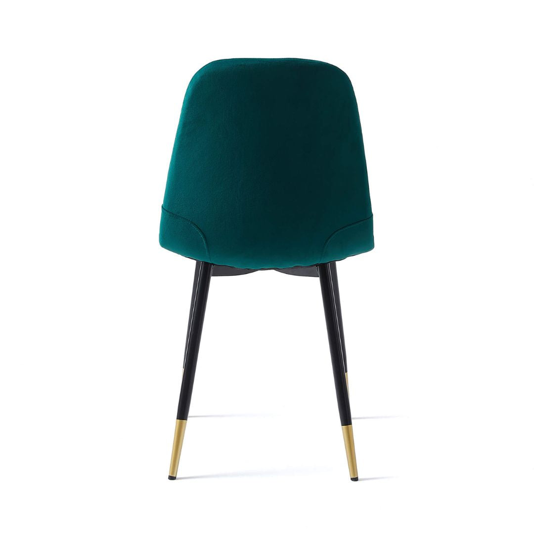 Two-piece green velvet dining chair set in a cozy dining environment.