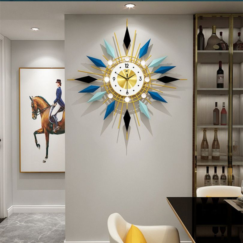 Front view of GeoAura modern clock showing geometric design and bold blue-gold finish
