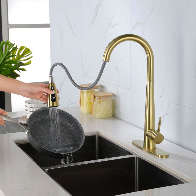 Close-up view of the elegant gold kitchen faucet showcasing the pull-out sprayer.
