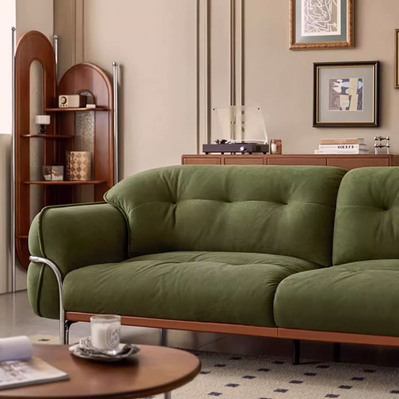 Three-seater version of the tufted sofa in a contemporary living room setting.