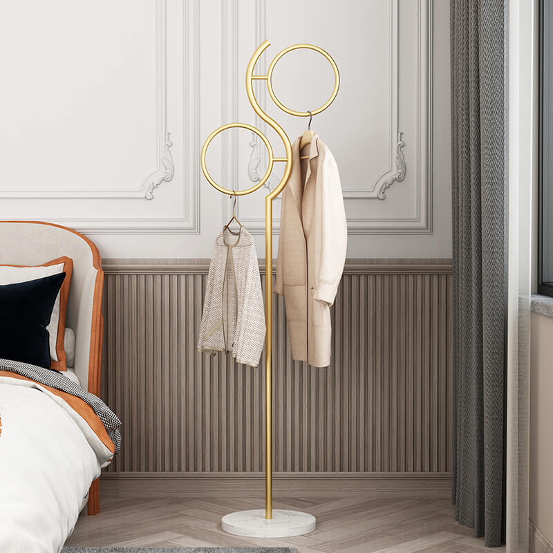 Sleek metal coat rack in a modern entryway, showcasing its stylish round base and two circular holds.
