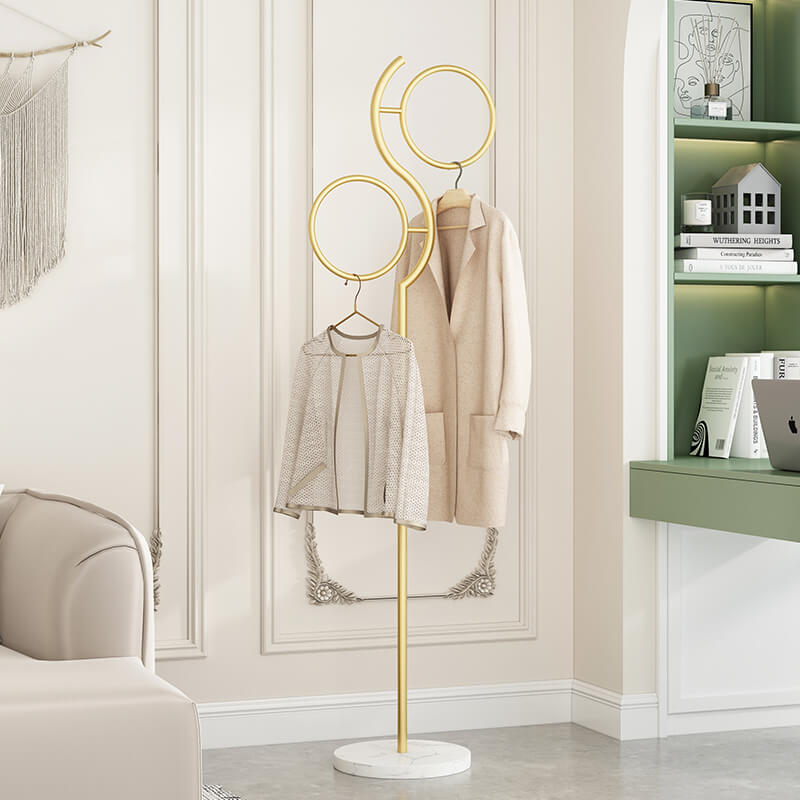 Close-up view of the metal coat stand, highlighting its gold finish and sturdy construction.