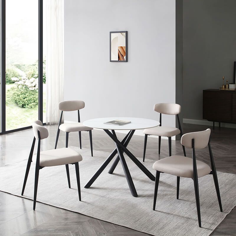 Side view of the elegant curved upholstered dining chair showcasing its light grey fabric and black metal frame.