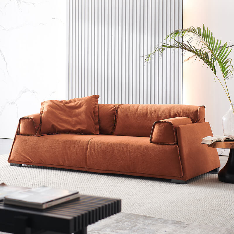 Elegant leather puff daybed sofa viewed from the side, showcasing its modern minimalist design.