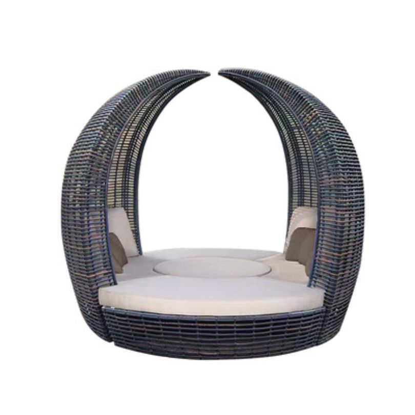 Outdoor view of the modular seating arrangement featuring the round rattan daybed, ideal for gatherings.