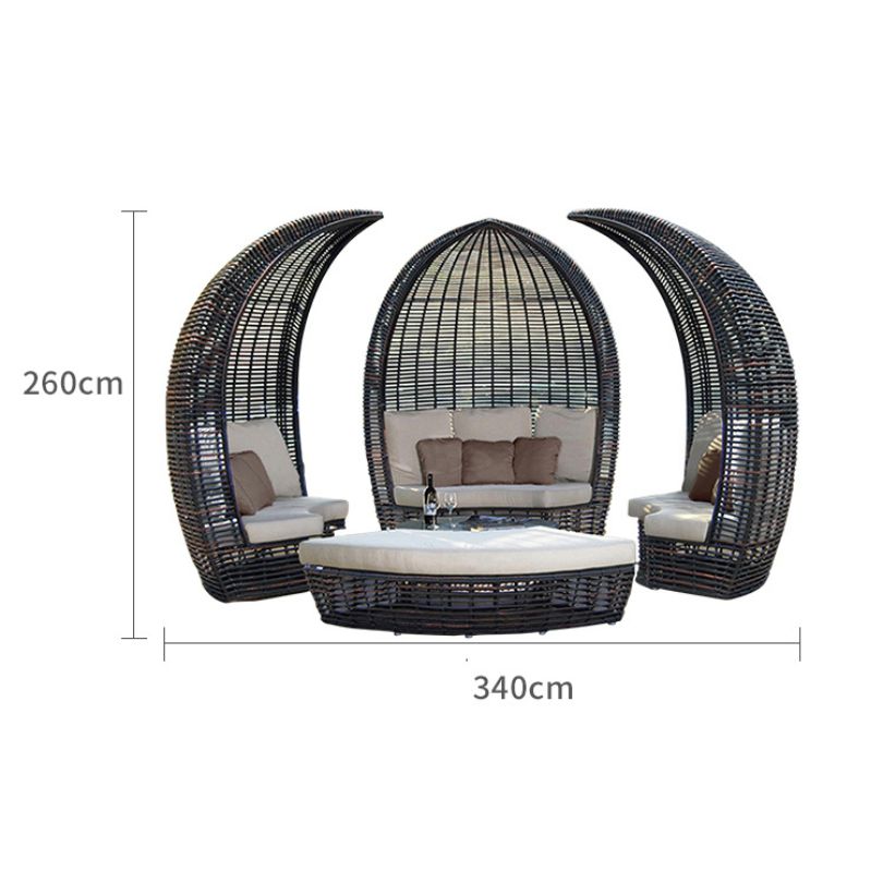 Elegant round rattan poolside daybed in a sunny garden setting, showcasing its sleek design and canopy.