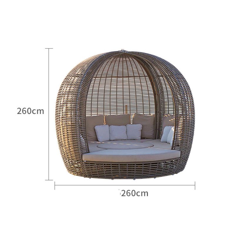 Outdoor view of the modular seating arrangement featuring the round rattan daybed, ideal for gatherings.