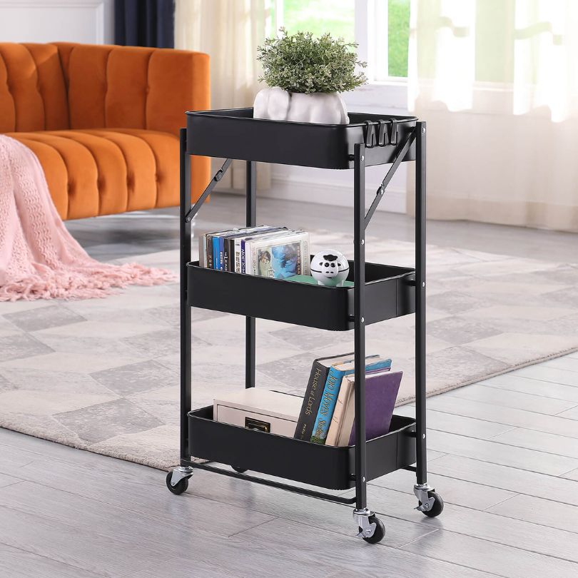 Sleek black rolling kitchen storage cart showcasing its mesh tray and sturdy wheels.
