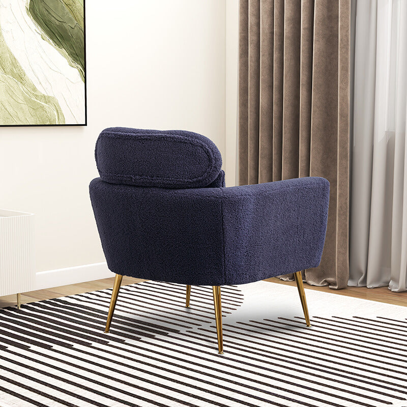 Navy boucle accent chair showcasing its plush fabric and gold metal legs from the side