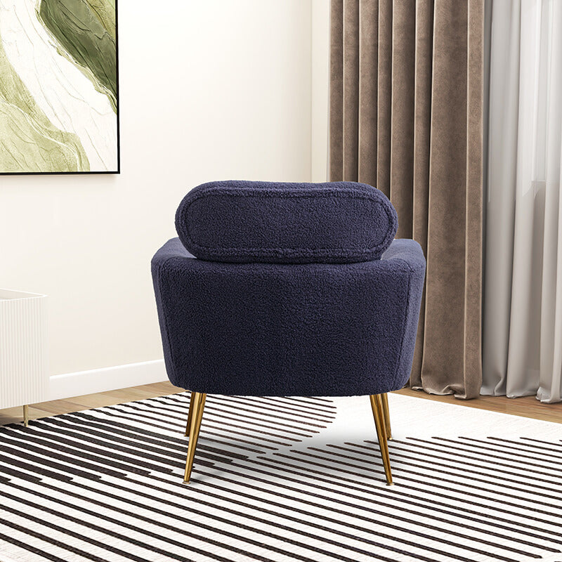 Close-up of the navy boucle accent chair with the throw pillow highlighting its comfort