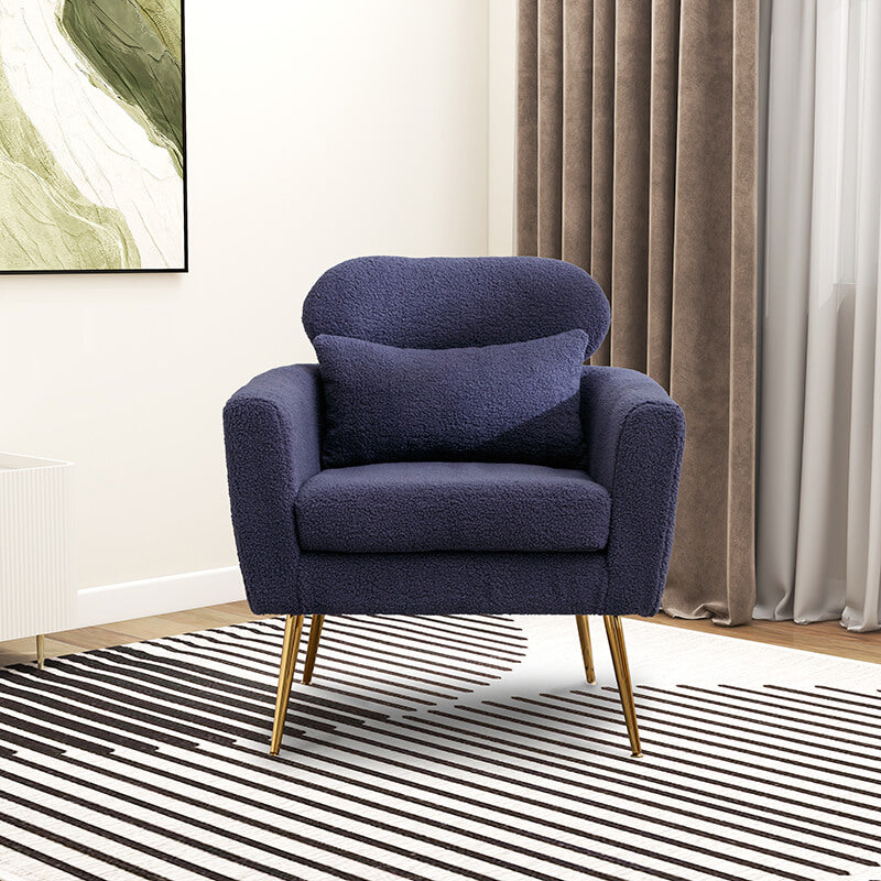 Close-up of the navy boucle accent chair with the throw pillow highlighting its comfort