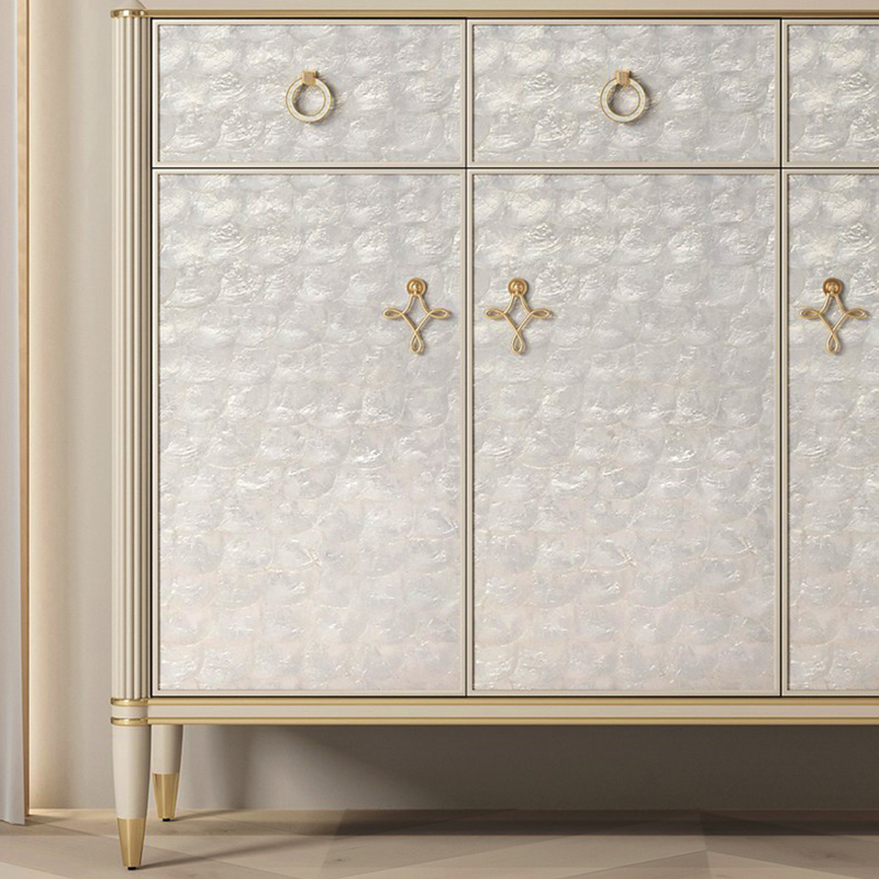 Elegant off-white shoe storage cabinet with doors, showing a side view in a bright entryway.