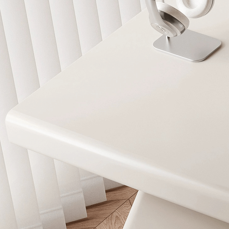 Front view of the sleek arc base executive desk showing its spacious surface and cream finish.