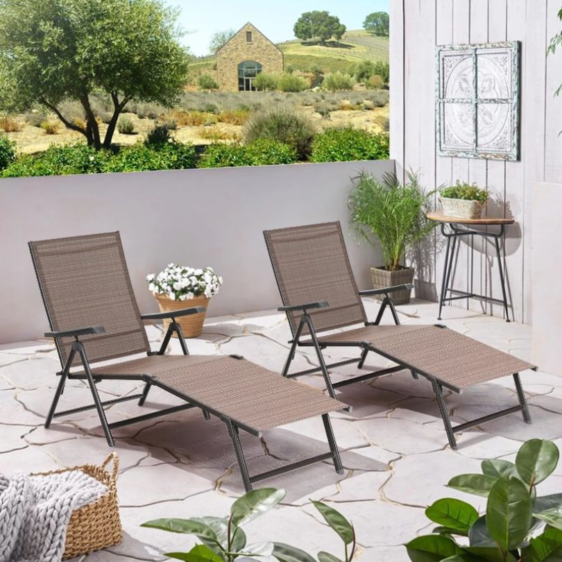 Modern outdoor lounge chair set on a deck during sunset.