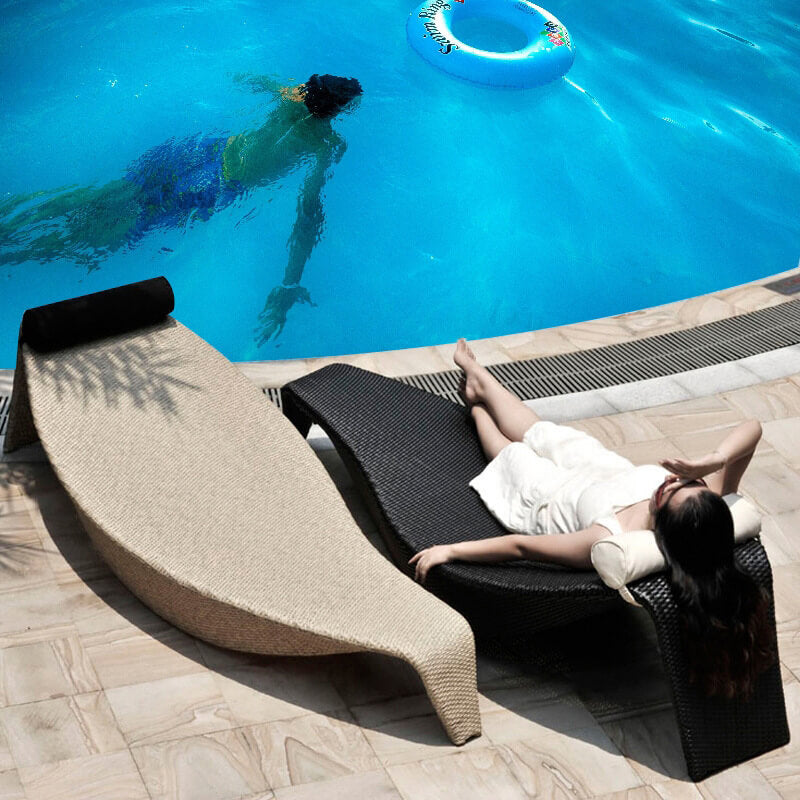 Angle view of the stylish rattan sun deck lounger on a patio