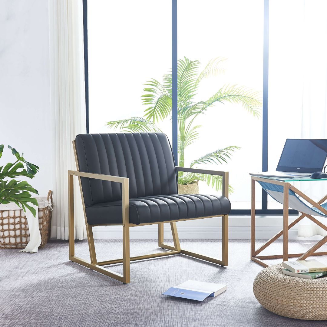 Close-up of the black PU leather upholstery on the gold steel frame armchair