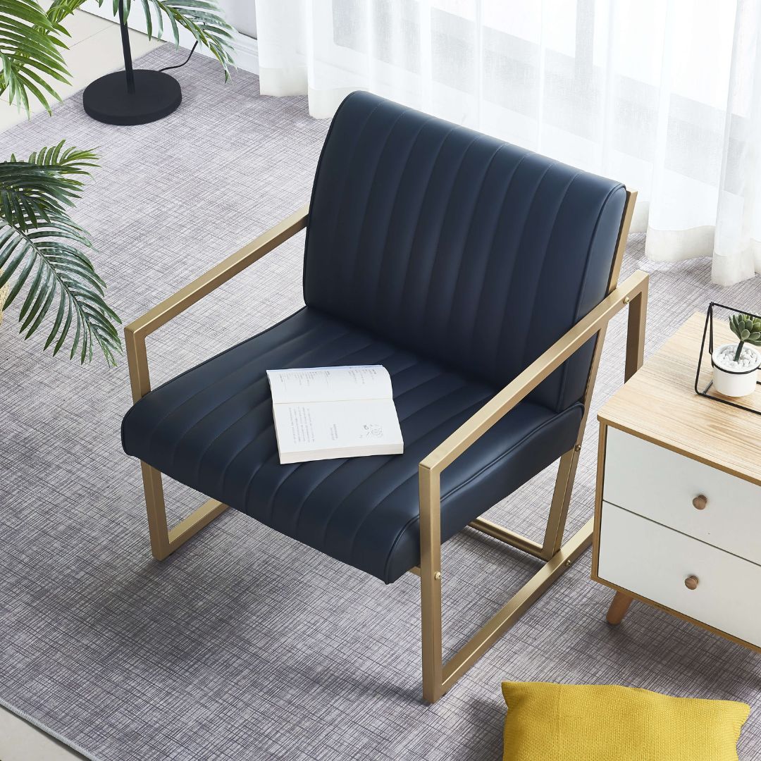 Close-up of the black PU leather upholstery on the gold steel frame armchair