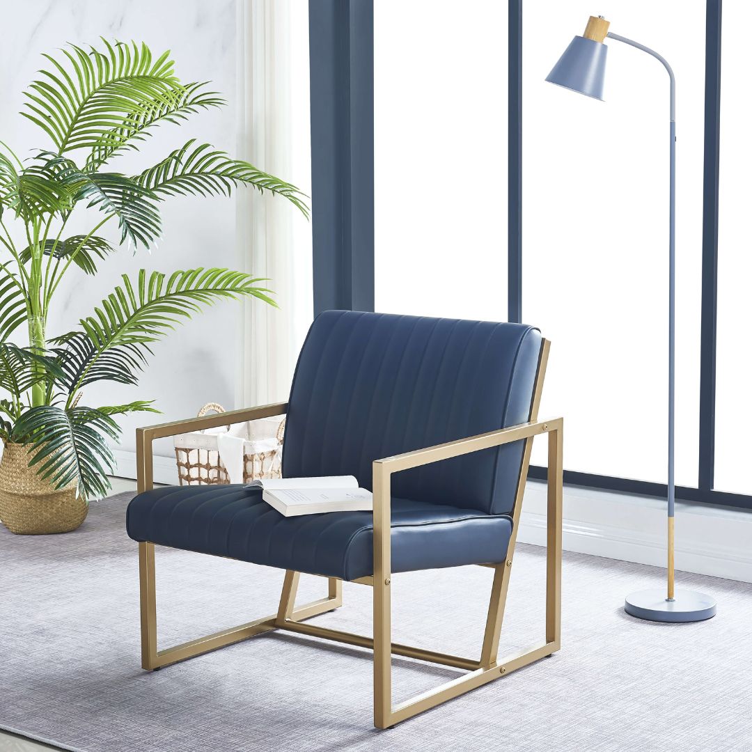 Luxe gold steel frame armchair with black leather upholstery, side view