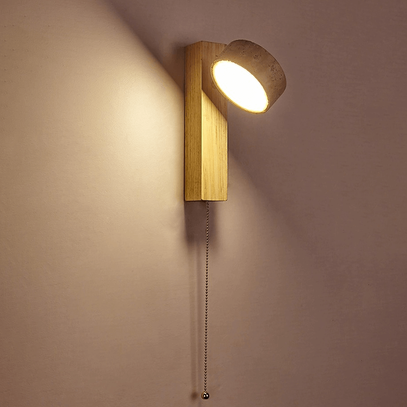 Sleek wooden LED wall lamp showcasing warm light in a cozy living room setting.