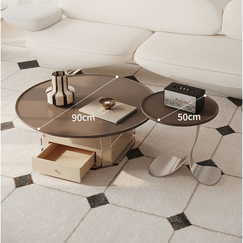 Angled view of round coffee table and side table in brown finish, styled in modern living room