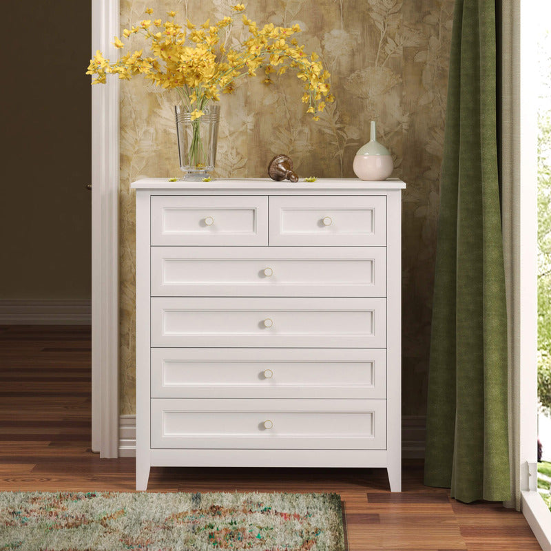 Modern antique white storage cabinet in a cozy bedroom setting, demonstrating its spacious drawers.