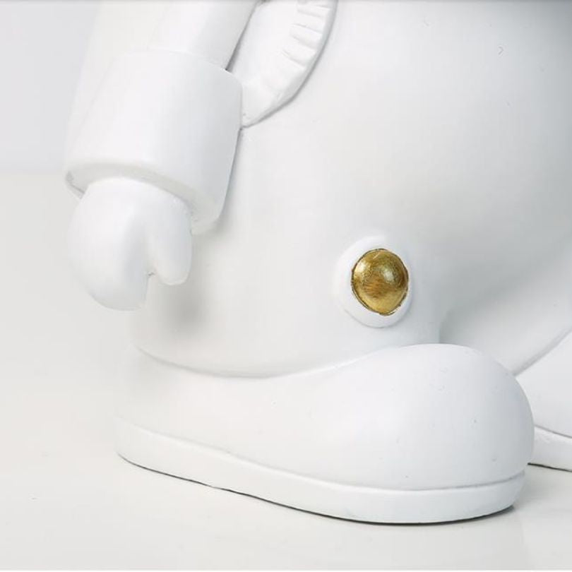 Gold Space Bunny Storage Sculpture on a shelf, demonstrating its stylish and modern aesthetic.