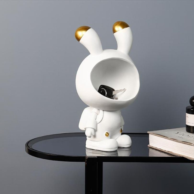 Gold Space Bunny Storage Sculpture on a shelf, demonstrating its stylish and modern aesthetic.