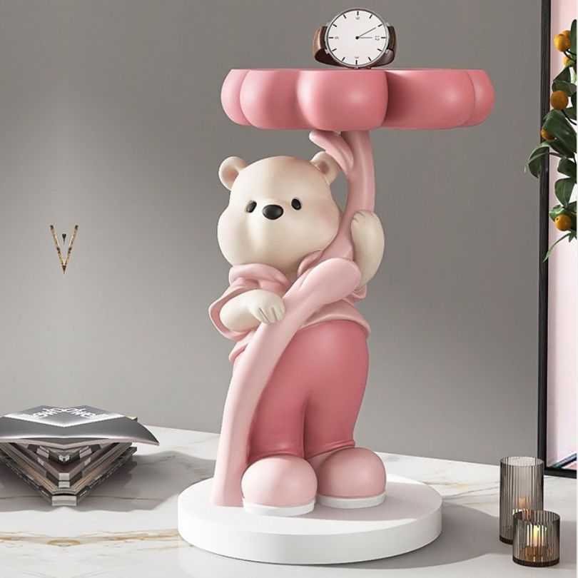 Colorful bear sculpture showcasing pink, brown, and blue details in a modern living room setting.